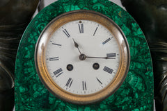 A PALATIAL PATINATED BRONZE & MALACHITE MANTEL CLOCK OF CUPID AND